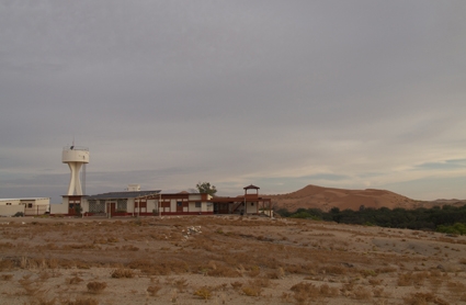 Gobabeb Training &amp; Research Centre with large sand dunes and Kuiseb riverbed in the background.